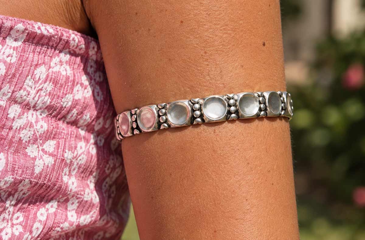 Oxidised silver Rana arm band worn on a woman's arm