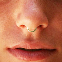 Non-piercing gold septum nose ring.