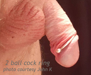 Two-ball frenulum cock ring worn beneath the glans