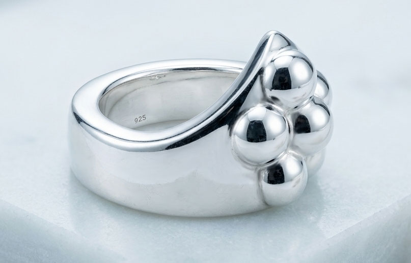 Heavy sculpted sphere cock ring with four outer half-spheres