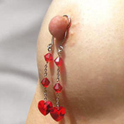 Alluring nipple clips with elegant hanging dangles for feminine body adornment.