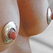 Bold circular nipple shields for elegant non-piercing breast adornment.