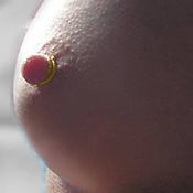 twisted single wrap gold nipple ring worn as breast jewellery